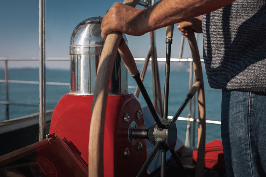 Professional yacht crew serving guests on Calypso boat, friendly Greek hospitality during a Mykonos private cruise.