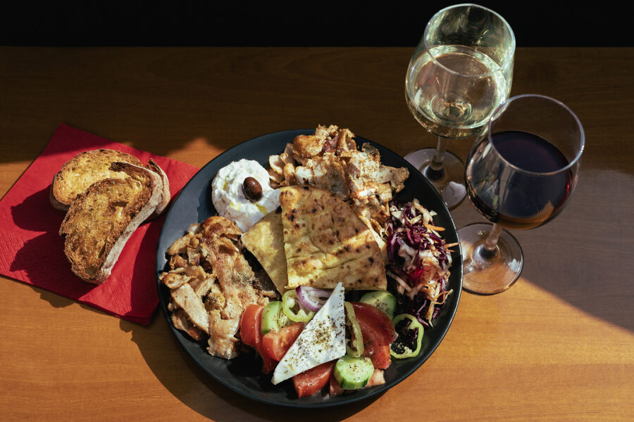 Mykonos boat trip lunch platter with chicken and pork gyros, fresh Greek salad, feta cheese, and tzatziki.